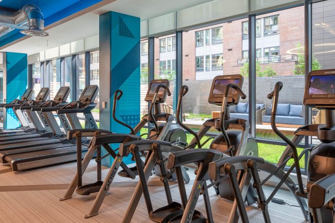 Modern fitness center with treadmills & elliptical machines. One of the top-notch amenities at The Kelvin in Washington, DC.