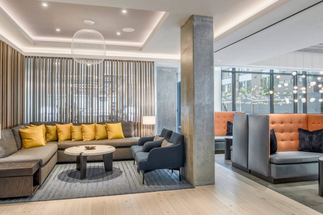Lounge area with plush couches, soft lighting & stylish decor. One of the top-notch amenities at The Kelvin in Washington, DC.